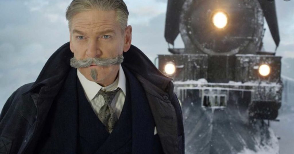 Poirot looking into the distance with the venice simpson orient express in the background
