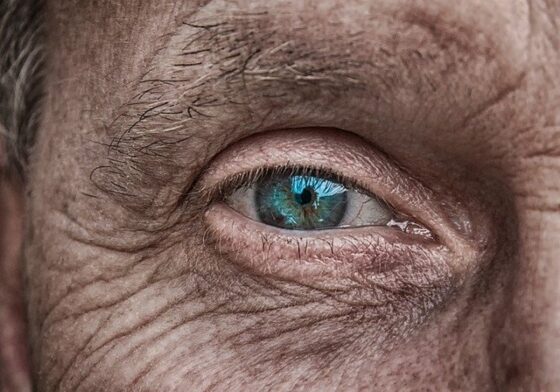 An older man looking right ahead with a blue eye